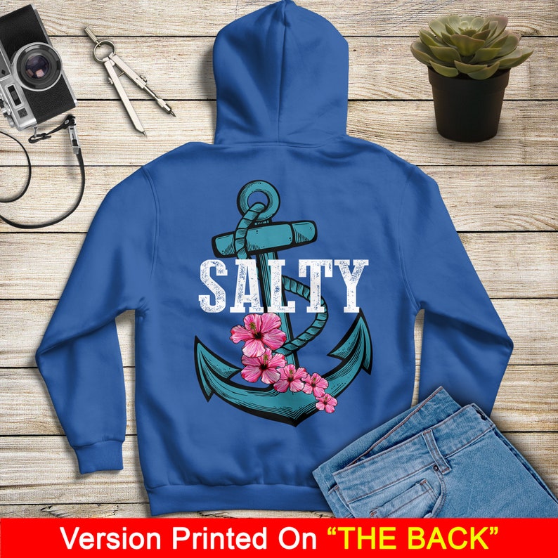 May include: A royal blue hoodie with a white anchor and the word "SALTY" printed on the back. Pink flowers are around the anchor.