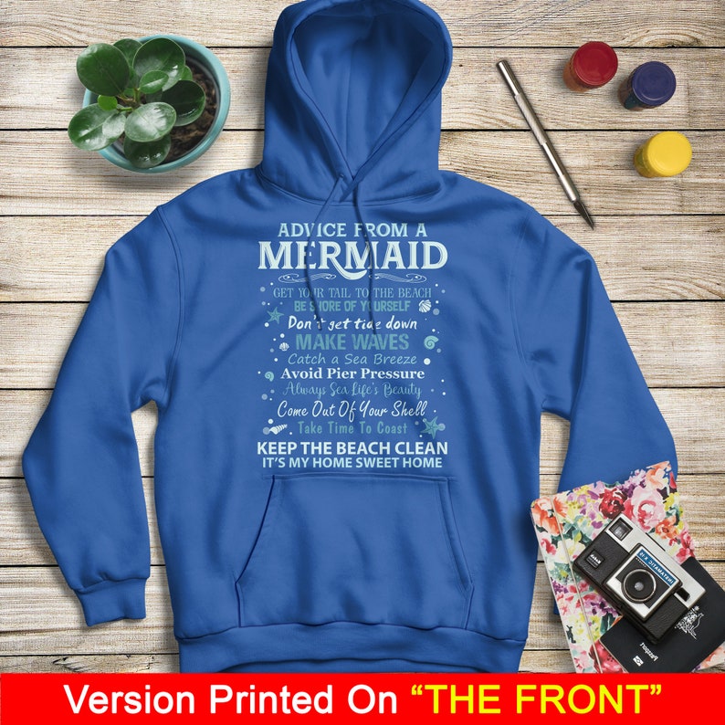 May include: Blue hooded sweatshirt with a white graphic print of advice from a mermaid. The text includes "Get your tail to the beach", "Don't get tide down", "Make waves", "Catch a sea breeze", "Avoid pier pressure", "Always sea life's beauty", "Come out of your shell", "Take time to coast", "Keep the beach clean", and "It's my home sweet home".