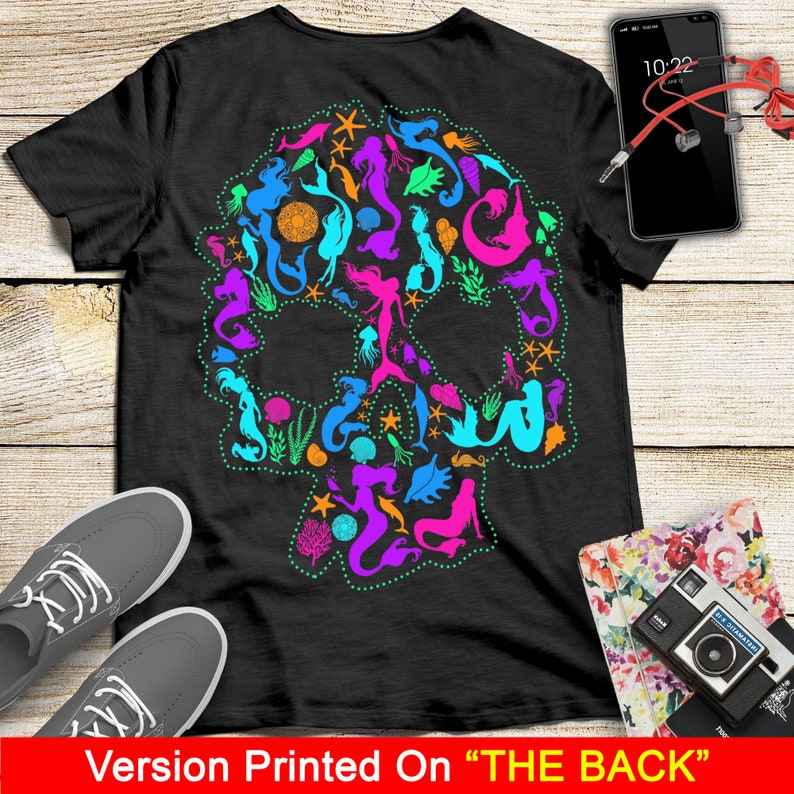 May include: Black t-shirt with a colorful mermaid skull design printed on the back. The skull is made up of mermaids, seashells, starfish, and other ocean-themed elements.