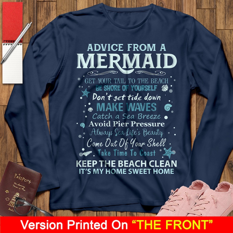 May include: A navy blue long-sleeved t-shirt with white text that reads "Advice from a Mermaid" and includes a list of tips for living a happy life. The text is surrounded by small blue and white illustrations of seashells, starfish, and waves.