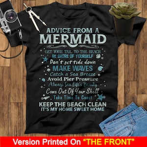 May include: Black t-shirt with white text that reads "Advice from a Mermaid" and includes a list of tips for living a happy life. The text is surrounded by small blue and white illustrations of seashells and starfish.
