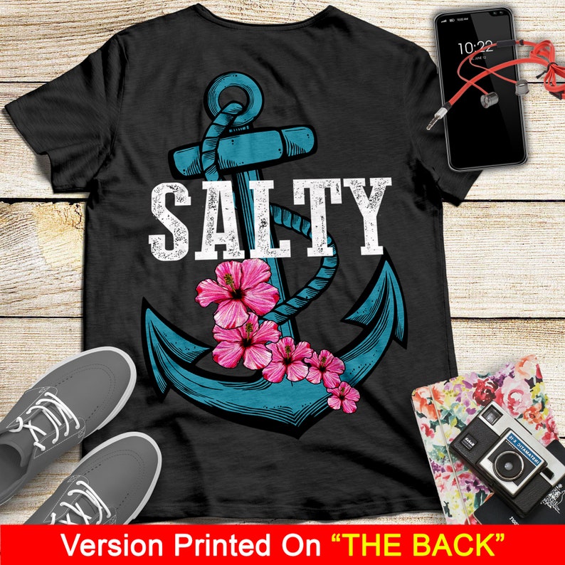 May include: A black t-shirt with a blue anchor and the word "SALTY" in white text. The anchor is surrounded by pink hibiscus flowers.