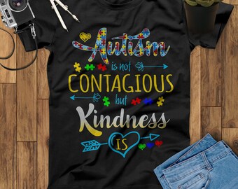 May include: Black t-shirt with a colorful graphic that says "Autism is not contagious but kindness is". The graphic features puzzle pieces and arrows.