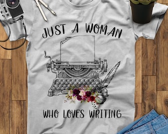 May include: A gray t-shirt with the text "Just a woman who loves writing" and a vintage typewriter with a quill pen and flowers.