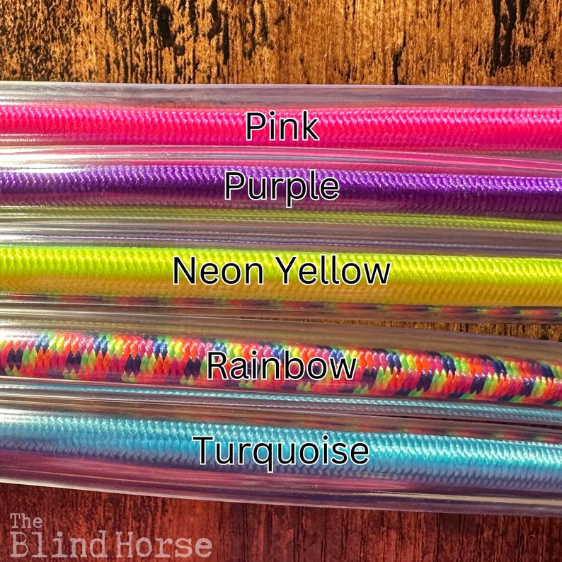 May include: Five parallel clear plastic tubes containing braided cords in pink, purple, neon yellow, rainbow, and turquoise colors. Each cord is labeled with its corresponding color name in white text. The brand name The Blind Horse is visible.