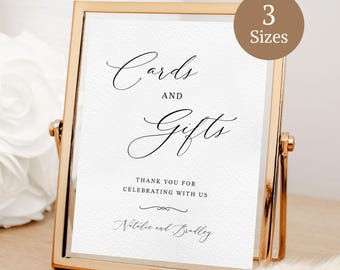 May include: A gold-framed sign with the words "Cards and Gifts" in elegant script. The sign also includes the text "Thank you for celebrating with us" and the names "Natalie and Bradley". A circular sticker indicates "3 Sizes".