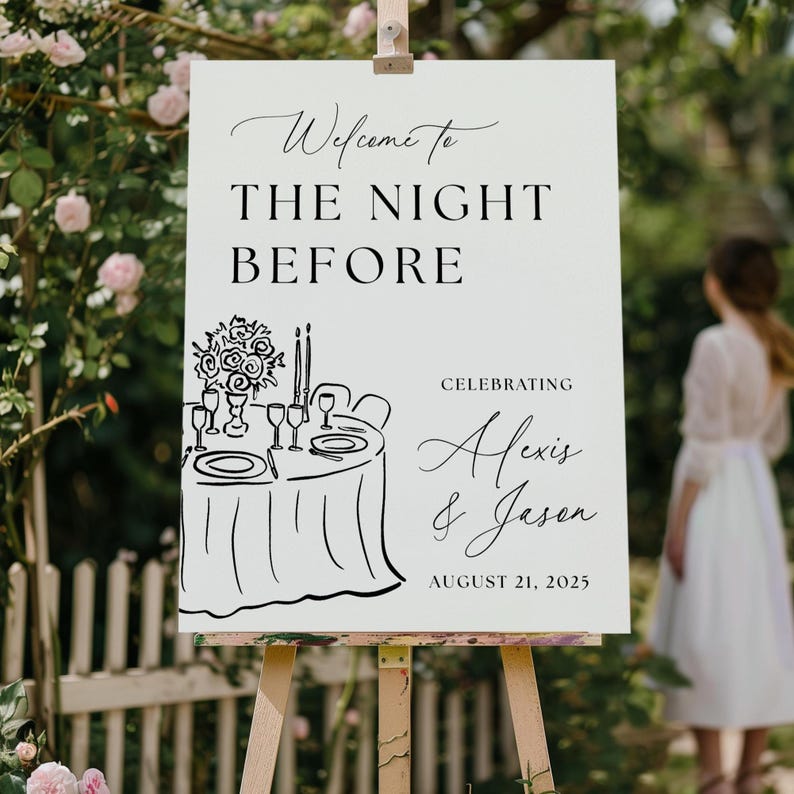 May include: A white sign on a wooden easel with the text "Welcome to THE NIGHT BEFORE" in black script. Below is a black and white illustration of a table setting. The sign celebrates Alexis & Jason, August 21, 2025.