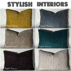 May include: Six different coloured corduroy throw pillows with the text "Stylish Interiors" on each pillow.