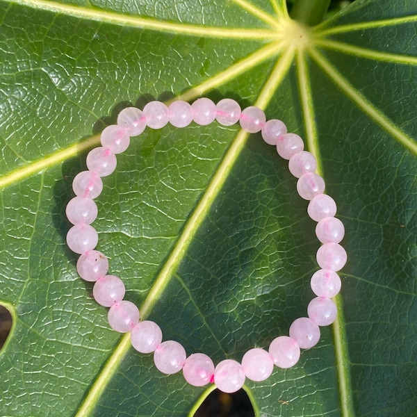 High grade rose quartz crystal beaded bracelet. 6mm rose quartz pink stone raw crystal beads tumbled.