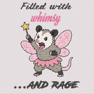 May include: A cross-stitch pattern featuring a gray opossum with pink fairy wings and a pink tutu, holding a yellow star wand. The text reads Filled with whimsy at the top and ...AND RAGE at the bottom in black and pink pixelated lettering.