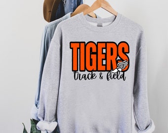 May include: Gray sweatshirt with the words "TIGERS track & field" in orange and black lettering. A white running shoe icon is next to the word "TIGERS".