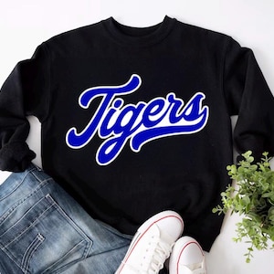 May include: Black sweatshirt with a blue and white "Tigers" graphic.