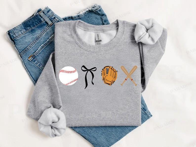 May include: Gray sweatshirt with a baseball, a black bow, a baseball glove, and two crossed baseball bats printed on the front.