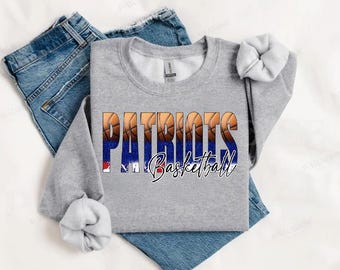 May include: A gray sweatshirt with the words "Patriots Basketball" printed on the front. The text is surrounded by a design of basketballs.