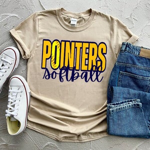 May include: A beige t-shirt with the text "POINTERS softball" in yellow and blue letters. The letters are outlined in blue and have a softball graphic inside them.