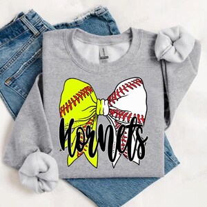 May include: A grey sweatshirt featuring a softball bow and the word "Hornets" printed on it.