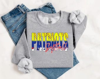 May include: Gray sweatshirt with the words "PATRIOTS Softball" in yellow, blue, and red letters with a baseball stitch pattern. The text is layered over a white and blue graphic.