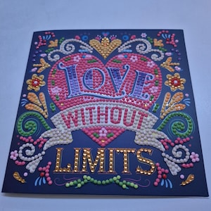 May include: A navy blue card featuring a heart design. The heart is filled with pink and red dots, with the word "LOVE" in purple dots. A banner reads "WITHOUT LIMITS" and the word "LIMITS" is in gold dots. Floral accents surround the heart.