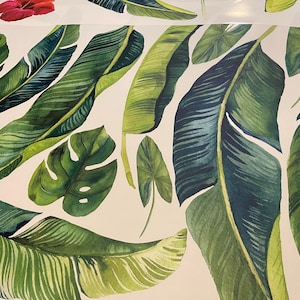 May include: A white background with a pattern of green and blue tropical leaves. The leaves are painted in a watercolor style and have a realistic look.