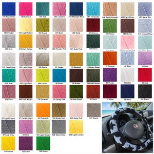 May include: A color chart displaying a wide array of yarn colors, each labeled with a number and name. The chart includes shades of blue, pink, green, yellow, and more. A crocheted steering wheel cover with a star pattern is in the bottom right.