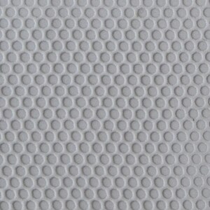 May include: A close-up of a white textured surface with a repeating pattern of small, round holes.