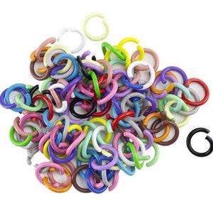 May include: A large pile of colorful metal jump rings in various sizes. The rings are made of metal and have a smooth, shiny finish. They are perfect for jewelry making, crafting, and other DIY projects.