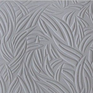 May include: A grey textured silicone rolling pin with a repeating pattern of stylised leaves. The rolling pin is designed for creating decorative patterns on fondant, dough, or clay.