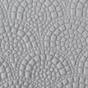 May include: A close-up of a white textured surface with a repeating pattern of small circles and squares. The pattern creates a subtle, elegant design.