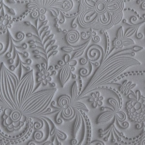 May include: A gray textured silicone stamp with a floral design. The design features a variety of flowers, leaves, and swirls.