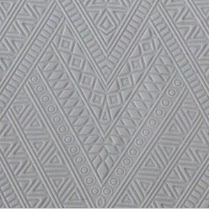 May include: A gray textured background with a repeating geometric pattern of triangles, squares, and circles.