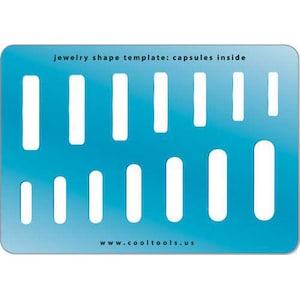 May include: A blue plastic template with cutouts for different shapes. The template is labeled "jewelry shape template: capsules inside" and "www.cooltools.us".