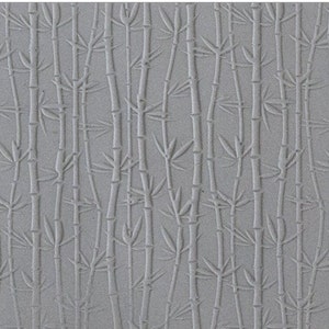 May include: A gray textured silicone baking mat with an embossed pattern of bamboo stalks. The mat is designed for use in the kitchen for baking and rolling out dough.