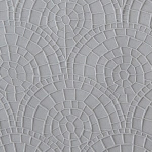 May include: A close-up of a gray textured surface with a repeating pattern of overlapping circles and squares.