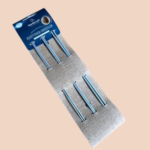 May include: A package of Hardicraft knitting needles. The needles are light blue and are held in place by a tan burlap-like material. The package has a dark blue header with the words "Hardicraft" and "Knitting Needles".