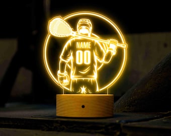 May include: A yellow illuminated 3D printed night light featuring a lacrosse player holding a lacrosse stick. The player is wearing a jersey with the text "NAME 00" on the back.