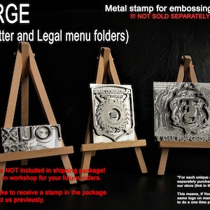 May include: Three metal stamps on wooden easels. The stamps are for embossing menu folders. The text on the stamps reads "LARGE (for A4, Letter and Legal menu folders)" and "!!! NOT SOLD SEPARATELY !!!".