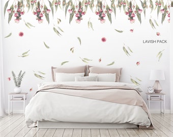 May include: A bedroom with a white bed and pink bedding. The wall is decorated with a floral wall decal featuring pink flowers and green leaves. The text "LAVISH PACK" is visible in the upper right corner of the image.