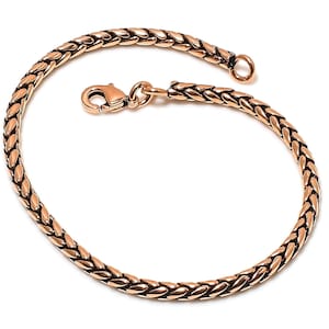 May include: A rose gold braided chain bracelet with a lobster clasp closure.