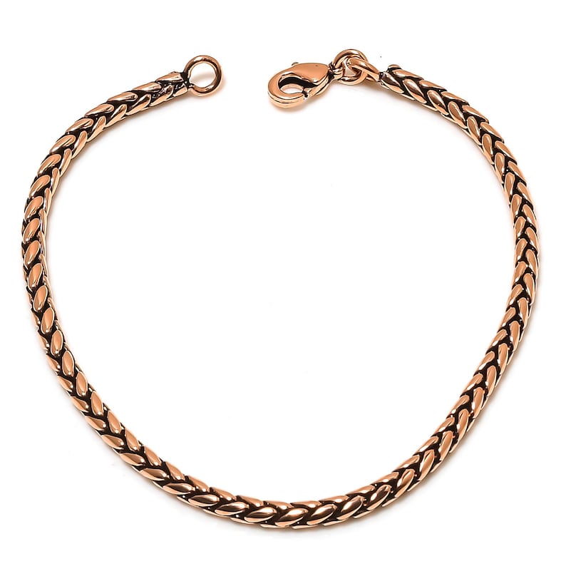 May include: A gold-toned braided chain bracelet with a lobster clasp closure.