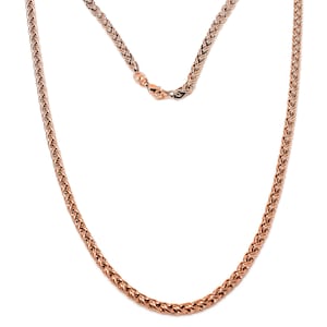 May include: A rose gold chain necklace with a braided design.