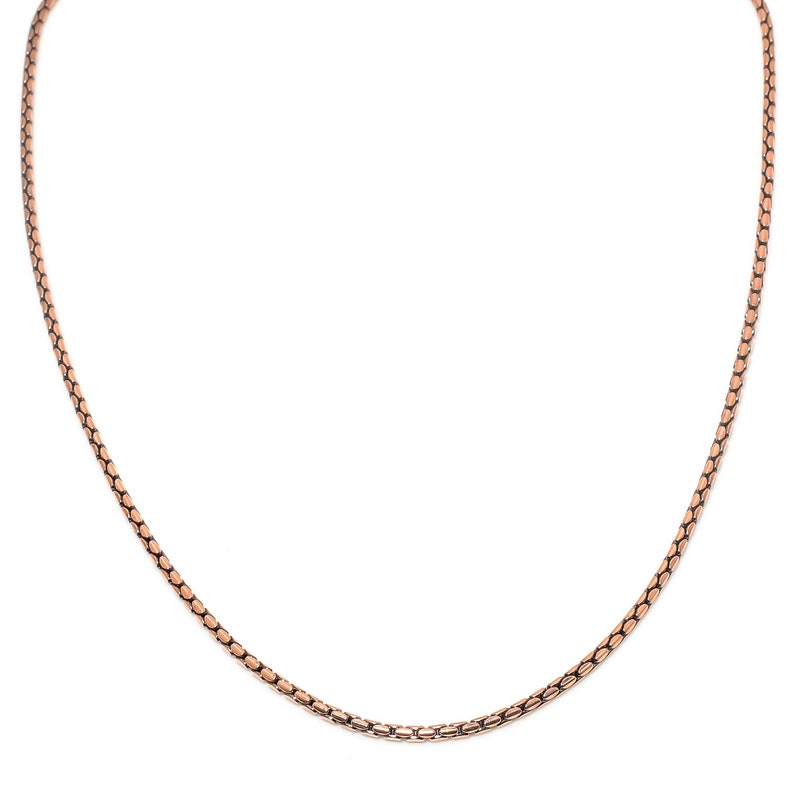 May include: A rose gold chain necklace with a delicate, box chain design.
