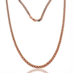 May include: A rose gold chain necklace with a braided design. The chain is made of metal and has a shiny finish.