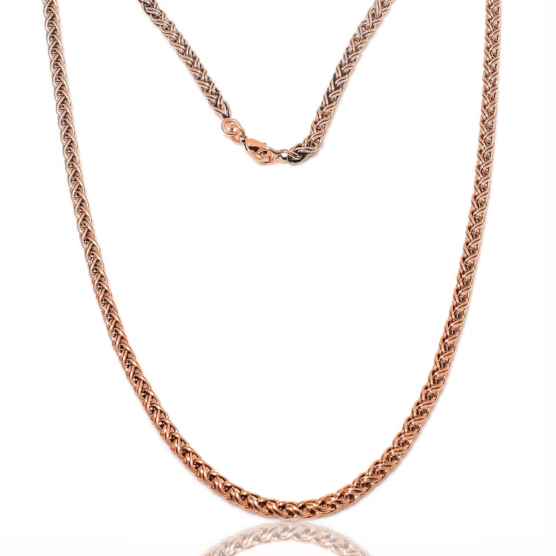 May include: A rose gold chain necklace with a braided design. The chain is made of metal and has a shiny finish.