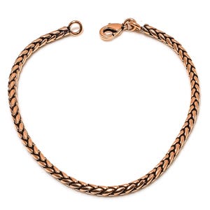 May include: A rose gold braided chain bracelet with a lobster clasp closure.