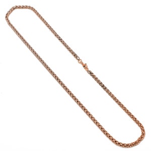 May include: A rose gold chain necklace with a braided design.
