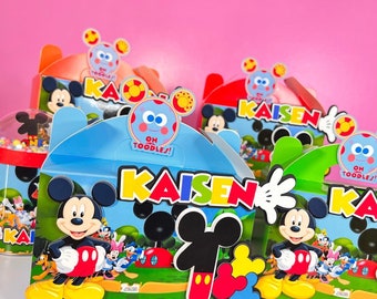 May include: A set of colourful Mickey Mouse themed party favour boxes with the name "Kaison" printed on them. The boxes are decorated with Mickey Mouse characters and have a blue and red colour scheme.