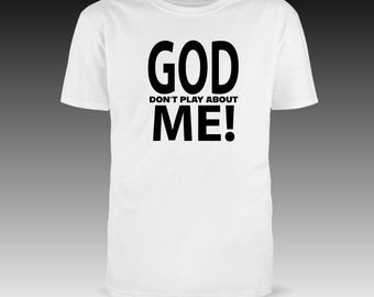 May include: A white t-shirt with the bold text "GOD DON'T PLAY ABOUT ME!" in black. The shirt has short sleeves and a crew neck, suitable for casual wear. The design is centered on the front.