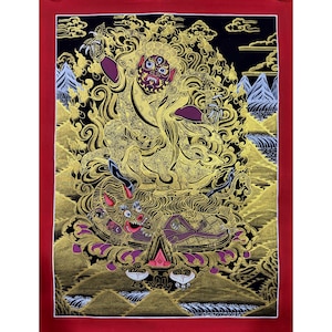 May include: A traditional Tibetan Buddhist thangka painting depicting a deity with multiple eyes and a fierce expression. The deity is depicted in a golden color with intricate details and is surrounded by flames. The painting is set against a black background with mountains and clouds in the background.