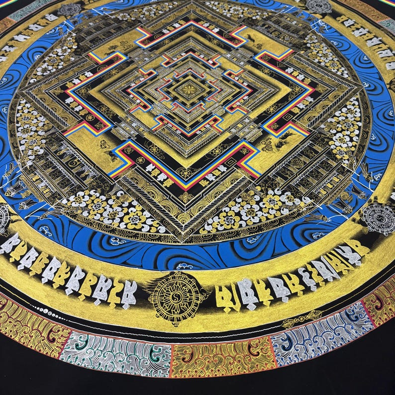 May include: A circular mandala with a square center, surrounded by a blue and gold border. The mandala is painted in gold, black, red, and blue. The center square is filled with intricate patterns and designs. The border is decorated with a repeating pattern of flowers and leaves.
