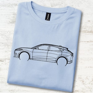 May include: A light blue t-shirt featuring a black line art illustration of a crossover vehicle in profile. The shirt has a crew neckline and a black brand label at the inner collar. The design depicts the side silhouette of the car.
